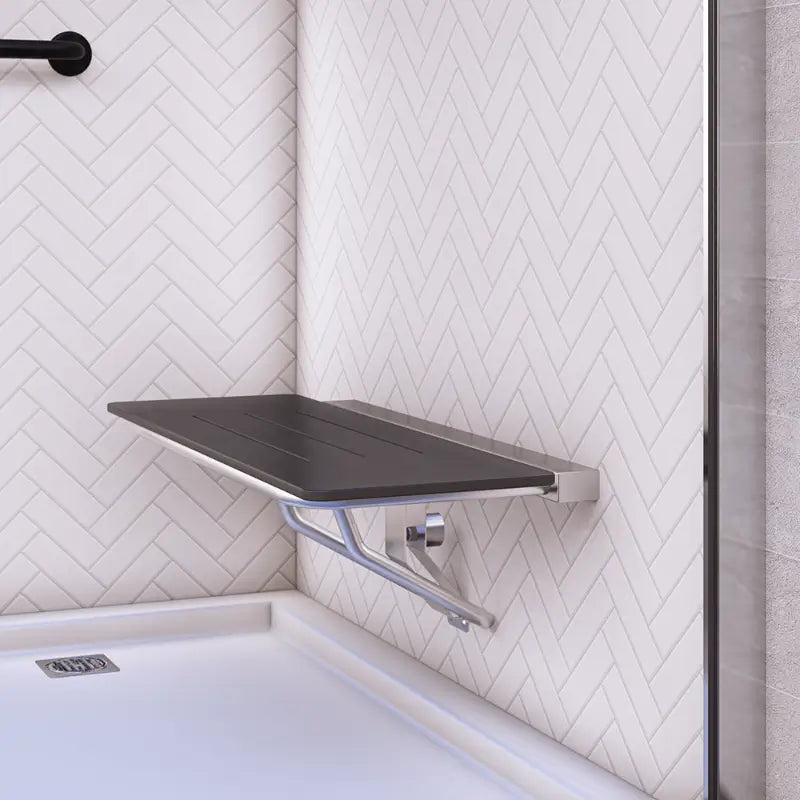 Metlam folding accessible shower seat in black laminate installed in a commercial shower — demonstrating space saving and accessibility.